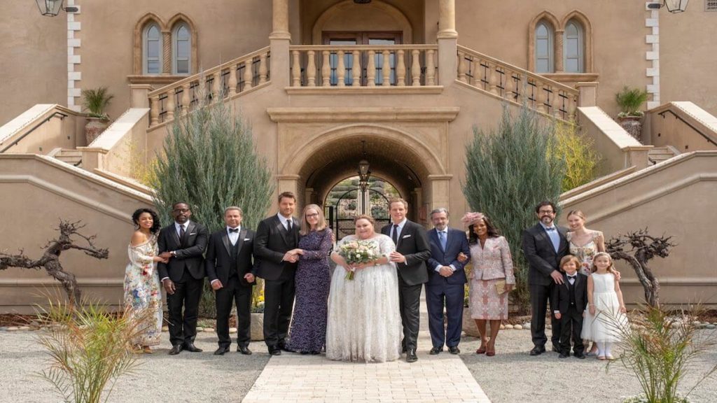 The cast of This Is Us posing for a photo at Kate's second wedding.