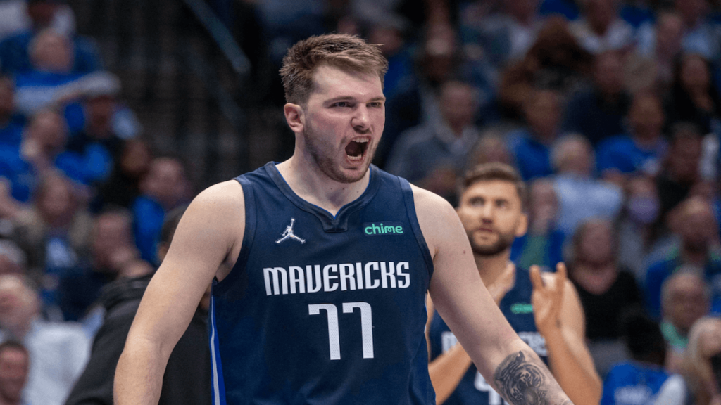 Luka Doncic flexing in a game for the Dallas Mavericks.